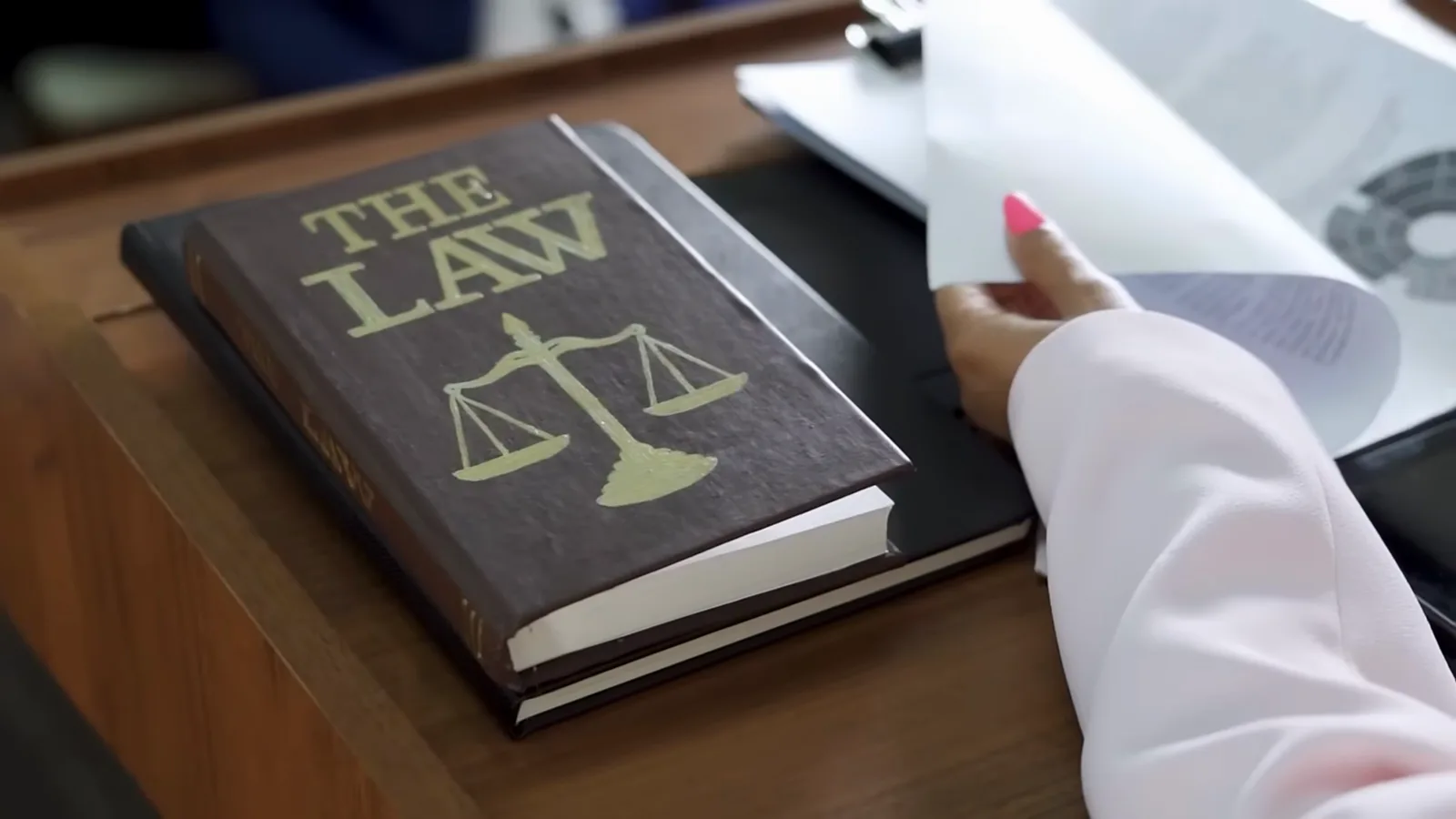 Leather law book with scales of justice beside a signed plea document in court, marking Alexander Vinnik's May 2024 guilty plea to money-laundering conspiracy Leather law book with scales of justice beside a signed plea document in court, marking Alexander Vinnik's May 2024 guilty plea to money-laundering conspiracy