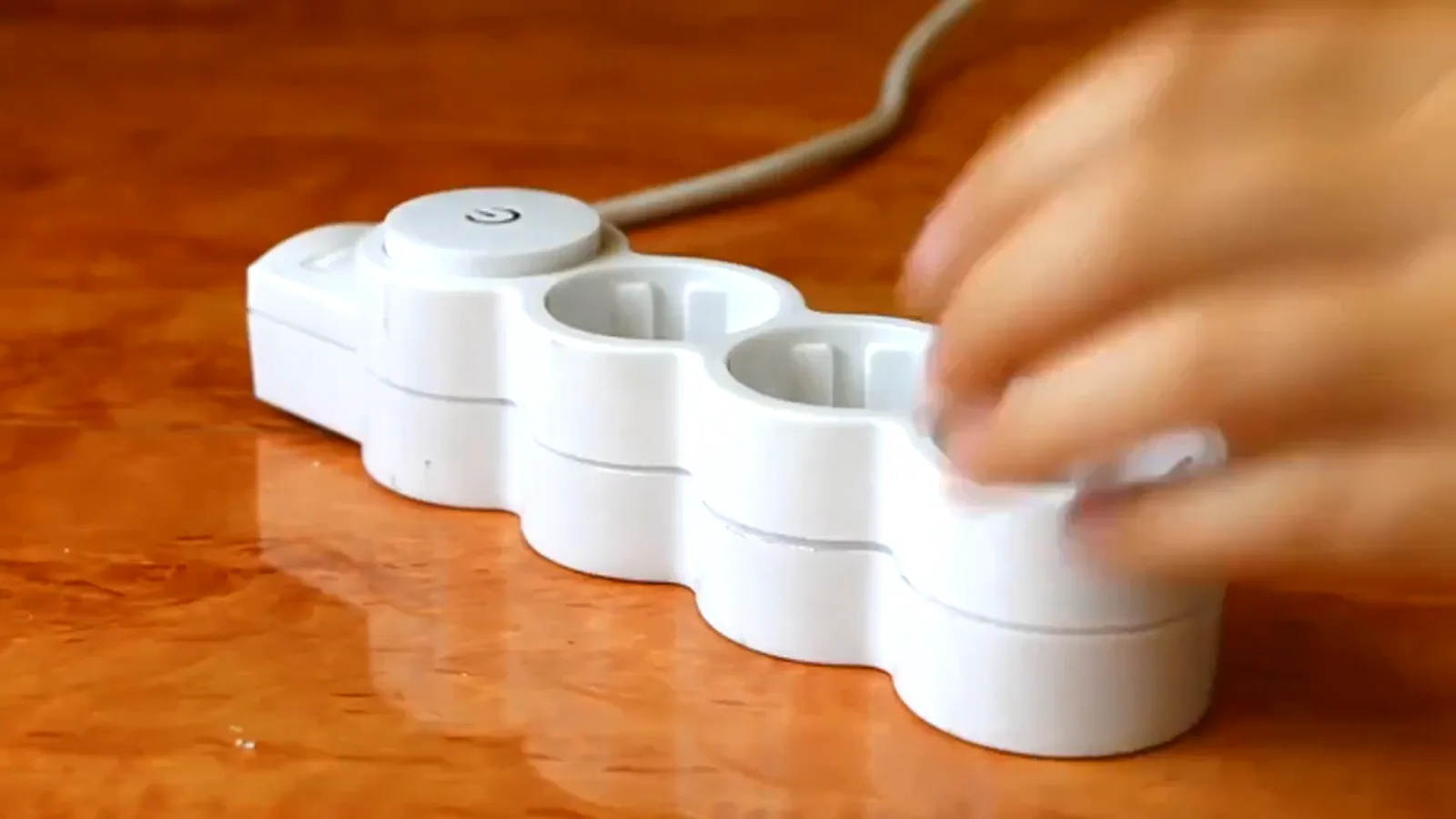 Hand switching off a white power strip on a wooden desk, the picture of idle mining rigs during the November 2018 breakdown Hand switching off a white power strip on a wooden desk, the picture of idle mining rigs during the November 2018 breakdown
