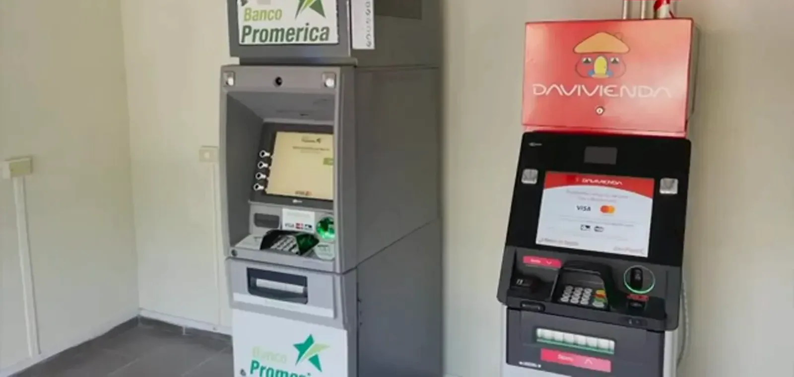 Traditional Banco Promerica cash machine standing beside a red bitcoin ATM, the two currency systems the IMF warned El Salvador's banks about Traditional Banco Promerica cash machine standing beside a red bitcoin ATM, the two currency systems the IMF warned El Salvador's banks about