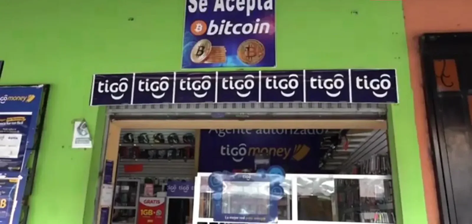 Green tigo money shop displaying a Se Acepta bitcoin sign above its entrance, bitcoin still accepted in El Salvador after the legal mandate ended Green tigo money shop displaying a Se Acepta bitcoin sign above its entrance, bitcoin still accepted in El Salvador after the legal mandate ended