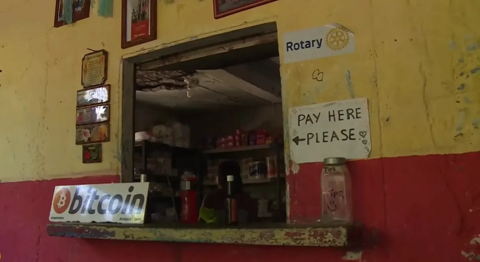Small Salvadoran shop window with a bitcoin sticker beside the counter and Pay Here painted on the wall after the bitcoin law made acceptance mandatory Small Salvadoran shop window with a bitcoin sticker beside the counter and Pay Here painted on the wall after the bitcoin law made acceptance mandatory