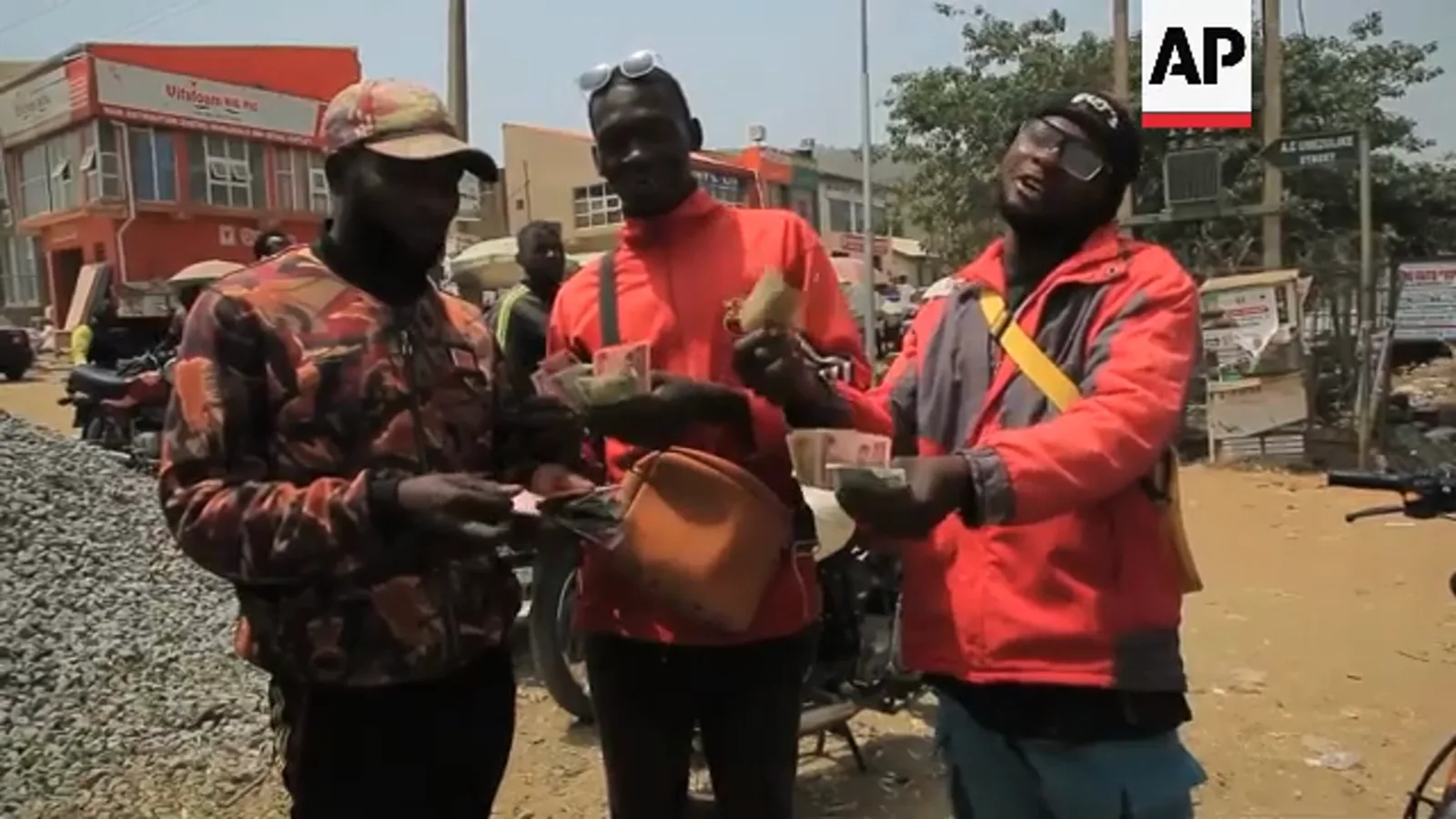 Street POS agents in red vests counting naira notes for customers after ATMs ran dry in the 2023 cash crunch