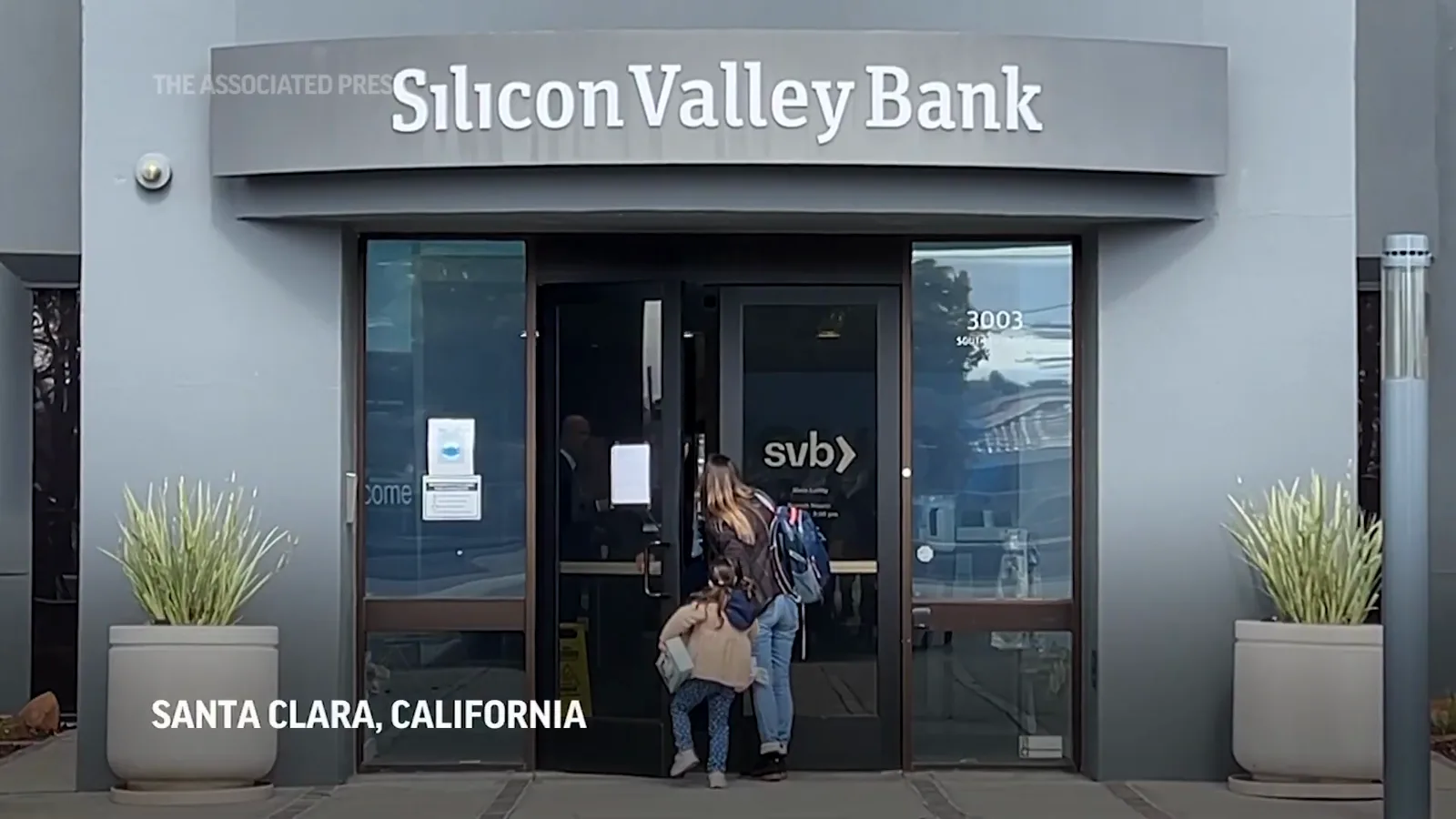 A depositor with a child entering the Silicon Valley Bank branch in Santa Clara after regulators seized the bank on March 10, 2023 A depositor with a child entering the Silicon Valley Bank branch in Santa Clara after regulators seized the bank on March 10, 2023